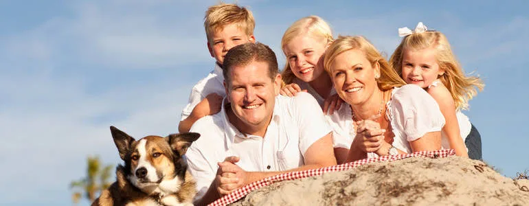 Family on beach with dog