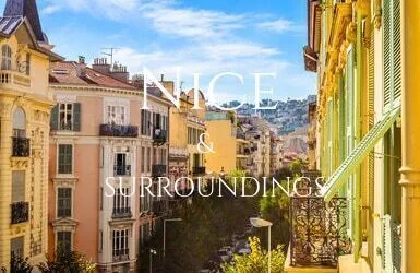 A street in Nice lined with houses painted in bright yellow and orange with green shutters and ornate metalwork on their small balconies.