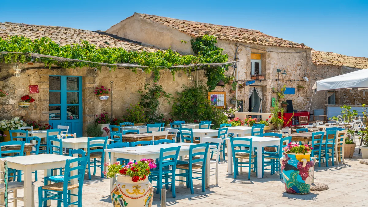 Italian village on lake with mountains in the background