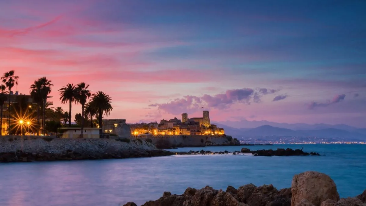 view over Antibes old town during sunset with mountains in the background